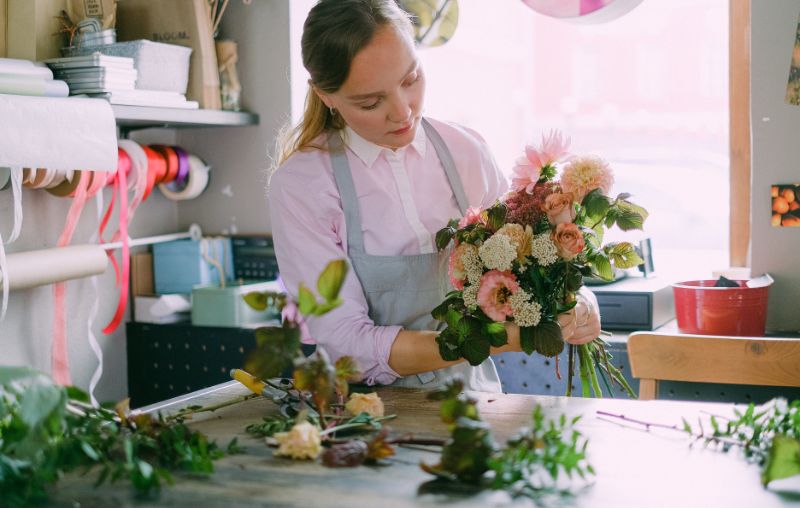 florist creating flowers bouquet